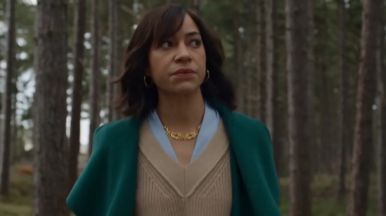 Megan looks around cautiously standing in the woods in Stay Close
