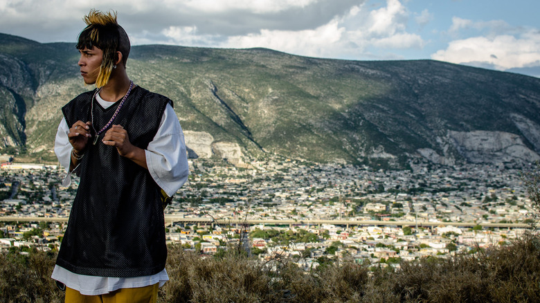 Ulises standing amidst the hills in I'm No Longer Here (2019)