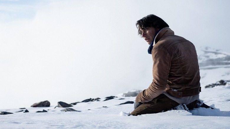 Numa sitting in the snow in Society of the Snow (2023)