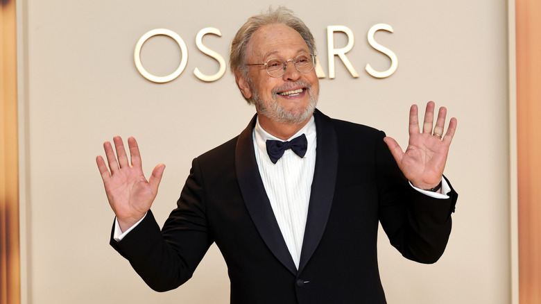 Billy Crystal poses in front of the Oscars logo before the 2025 ceremony
