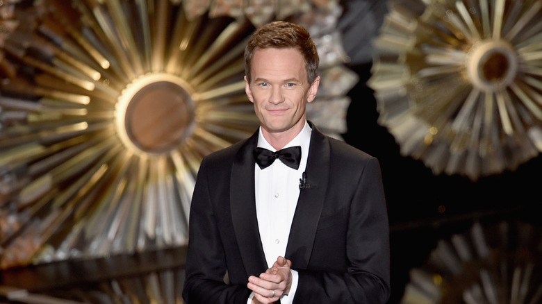 Neil Patrick Harris smiles while standing on the Oscar stage