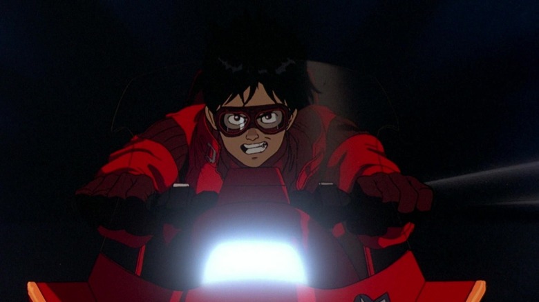 Kaneda rides a motorcycle at night in "Akira" (1988)