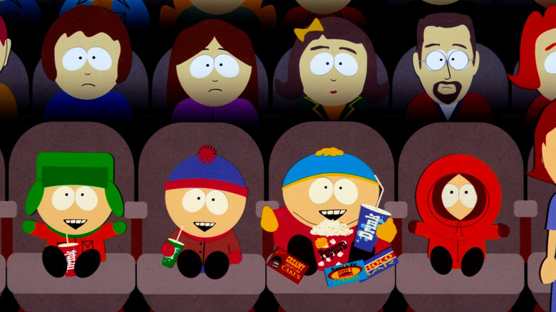 Stan, Kyle, Kenny, and Cartman are seated in a movie theater in "South Park: Bigger, Longer, & Uncut" (1999)