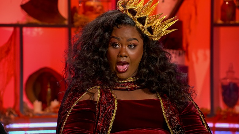 Nicole Byer in a gold crown and red robe on an episode of "Nailed It!"