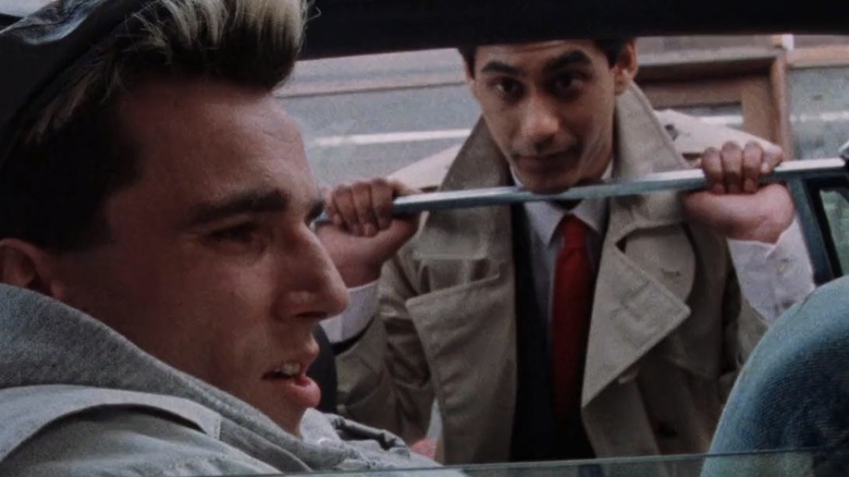 Johnny sitting in a car while Omar talks to him from the open window in "My Beautiful Laundrette"