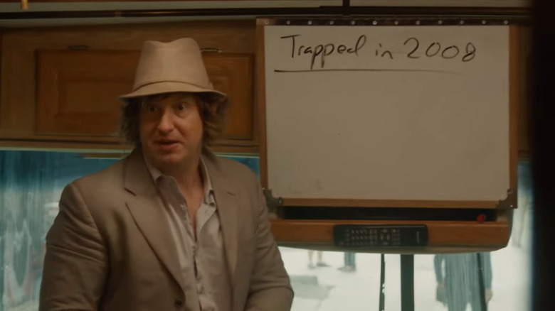Matt in front of a whiteboard that reads "Trapped in 2008" in "Nirvanna the Band the Show the Movie" (2026)