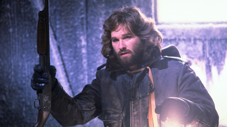 MacReady holding weapon and lantern in "The Thing" (1982)