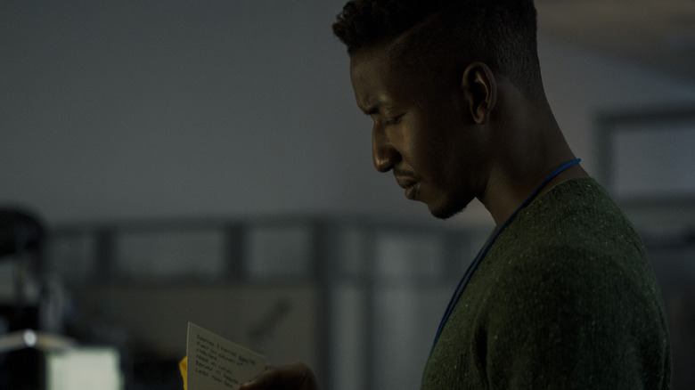 Dan Turner reading through cards in "Archive 81"