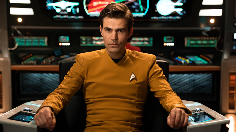 James T. Kirk sitting in the captain chair in "Star Trek: Strange New Worlds."