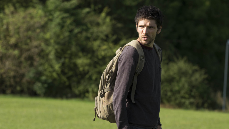 Leo in field looking over his shoulder in Humans