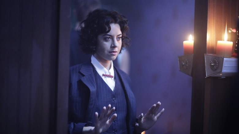 Lenny in suit holding hands up in Legion