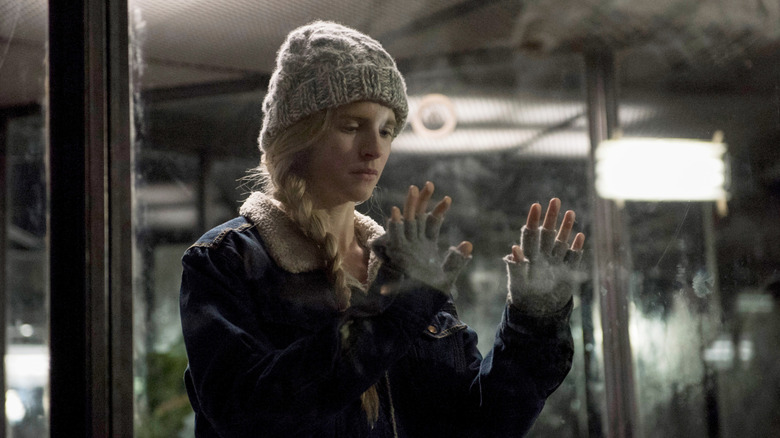 Prairie holding hands up to glass in The OA