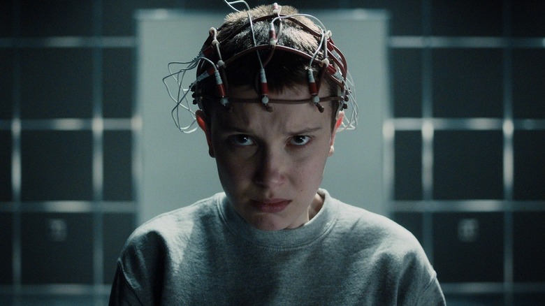 Eleven looking scared while taking part in experiments in "Stranger Things"