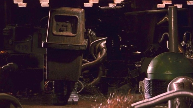A gonk droid walking through the inside of a Jawa sandcrawler in "Star Wars: A New Hope"