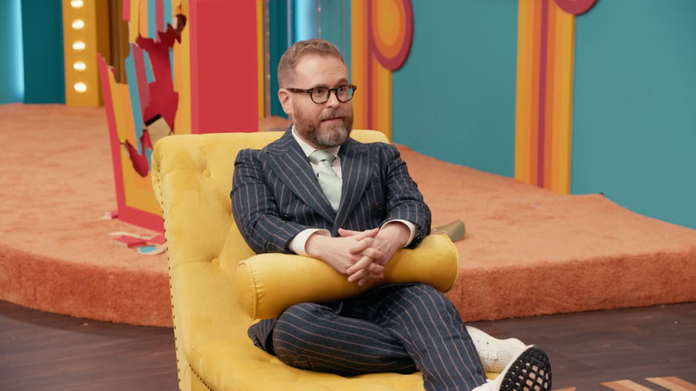 Sam sitting on a chaise talking to a therapist on Game Changer