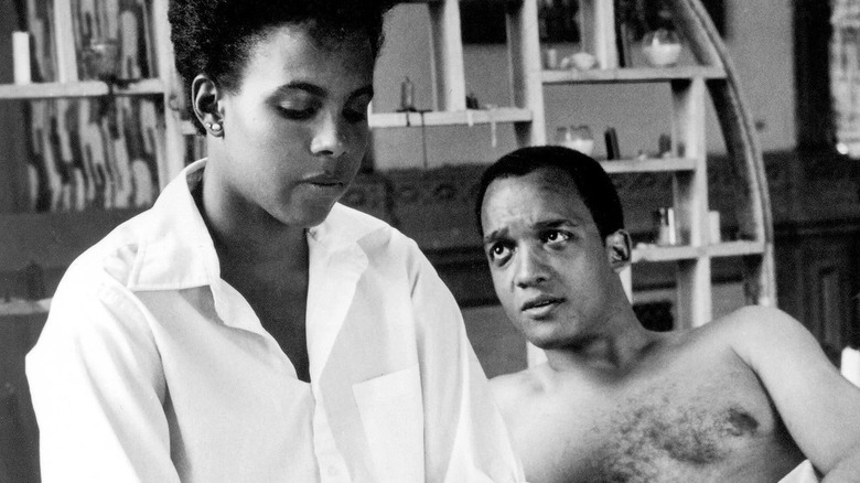 Nola sits in bed with Greer in She's Gotta Have It