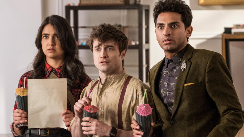 Eliza, Craig, and Sanjay standing before God in fright, holding tropical cocktails