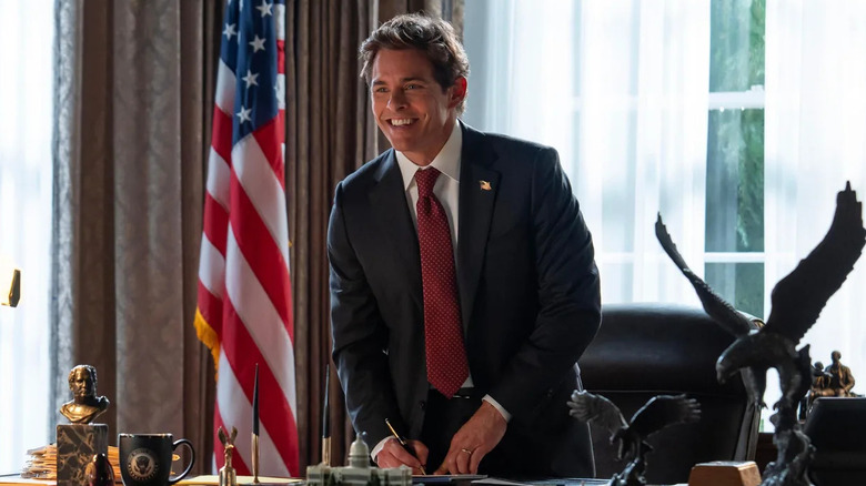 President Cal Bradford standing at his desk in the Oval Office