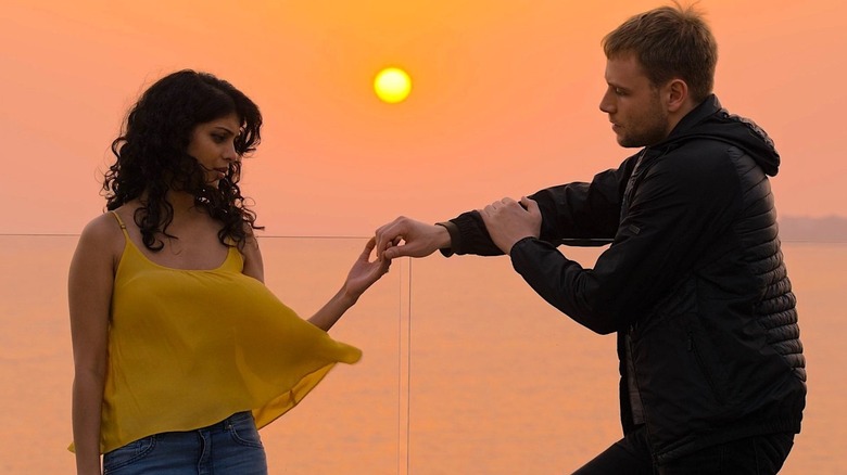 Kala and Wolfgang holding hands at sunset