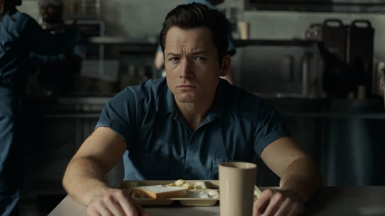 Keene sits at a table furrowing his brow in Black Bird