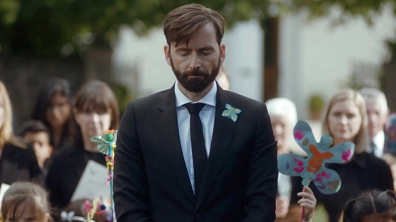 Tom stands solemly at a funeral in Deadwater Fell