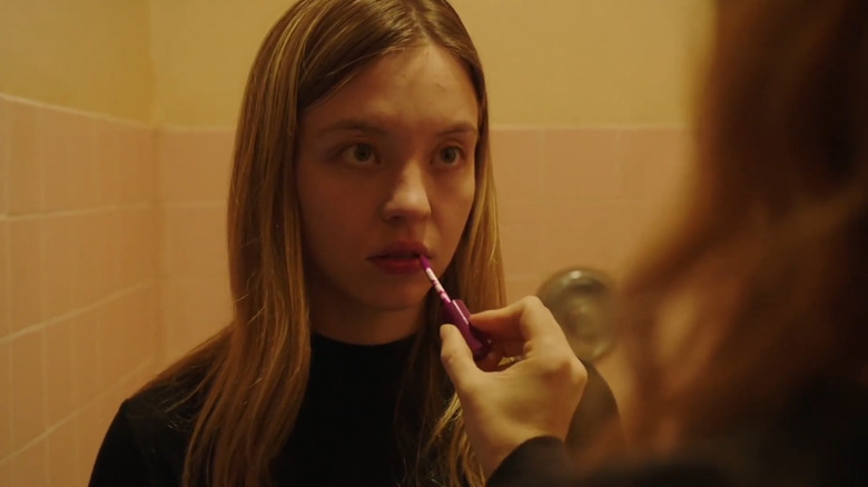Alice having lipstick put on in Sharp Objects
