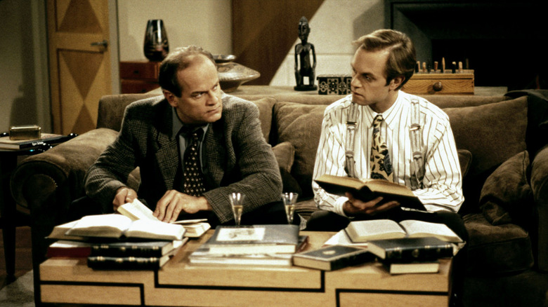Frasier and Niles reading books together on the couch in 