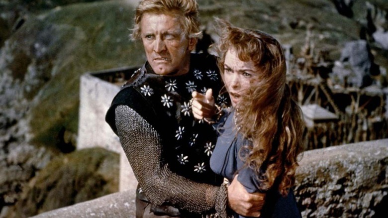 Einar and Morgana embracing on a wall in "The Vikings (1958)"