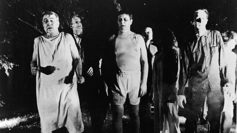 Zombies walk through the woods in "Night of the Living Dead" (1968)