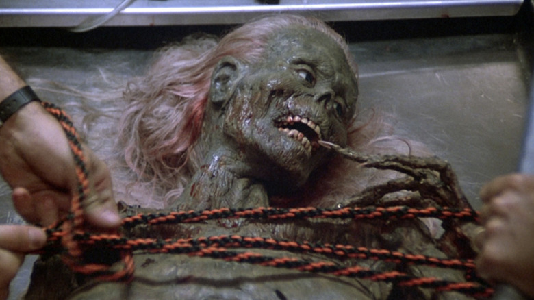 A zombie gets tied down to a table in "The Return of the Living Dead" (1985)