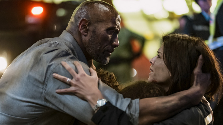 Will and Sarah embracing emotionally in Skyscraper (2018)