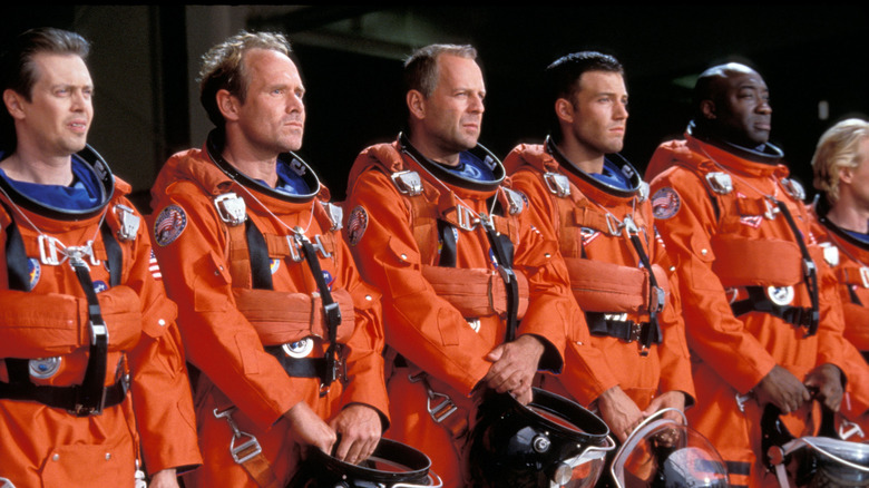 Harry S. Stamper and his crew lined up in spacesuits in Armageddon (1998)