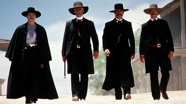 Doc Holliday and the Earp brothers walk down the street in Tombstone (1993)