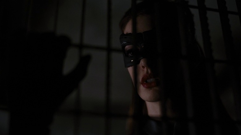 Catwoman staring behind bars in The Dark Knight Rises (2012)
