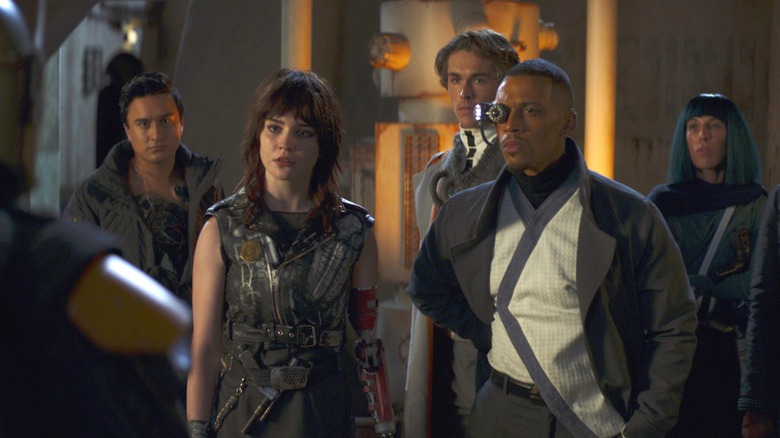 The Mod gang talking to Boba Fett on the streets of Mos Espa at night in The Book of Boba Fett