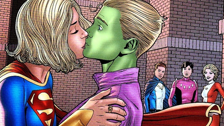 Supergirl smooching Brainiac 5 as members of the Legion of Superheroes look on