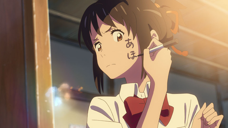 Mitsuha writes on her cheek in "Your Name" (2016)