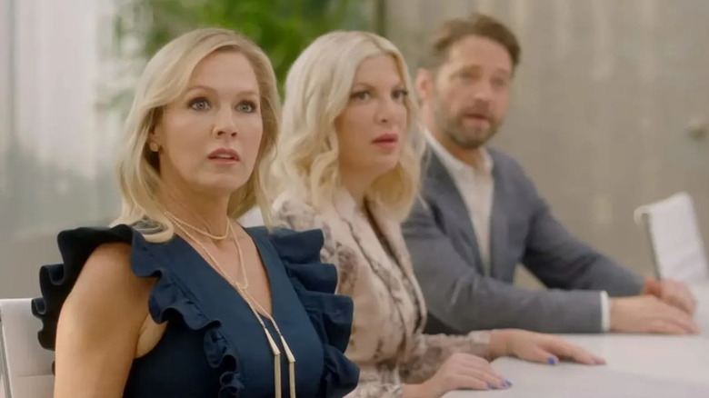 Jenny, Tori, and Jason sit at a conference table in BH90210