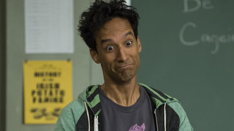 Abed standing at the head of the classroom, looking disheveled, after watching every Nicholas Cage movie for a course