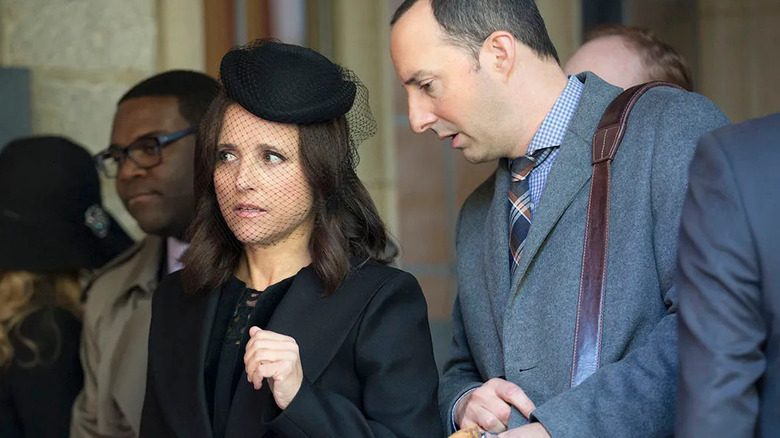 Selina Meyer standing in a crowd with Richard and Gary in Veep