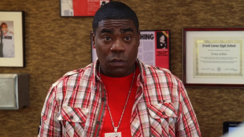 Tracy Jordan standing in front of a wall covered in paraphernalia in "30 Rock"