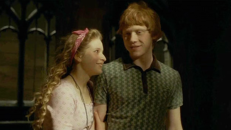 Lavender smiling up at Ron in a Hogwarts hallway in Harry Potter and the Half-Blood Prince