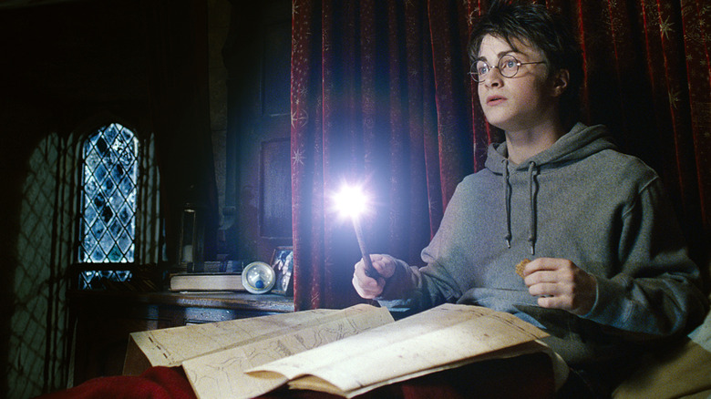 Harry using the Marauder's Map in his dorm in Harry Potter and the Prisoner of Azkaban