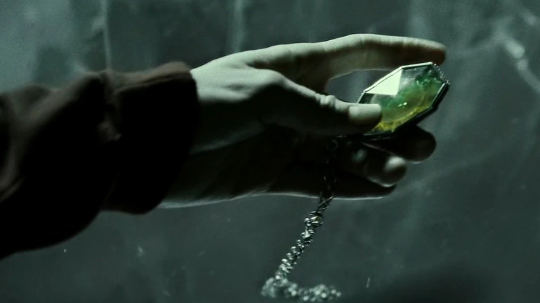 Hand holding R.A.B.'s locket in Harry Potter and the Deathly Hallows: Part 1