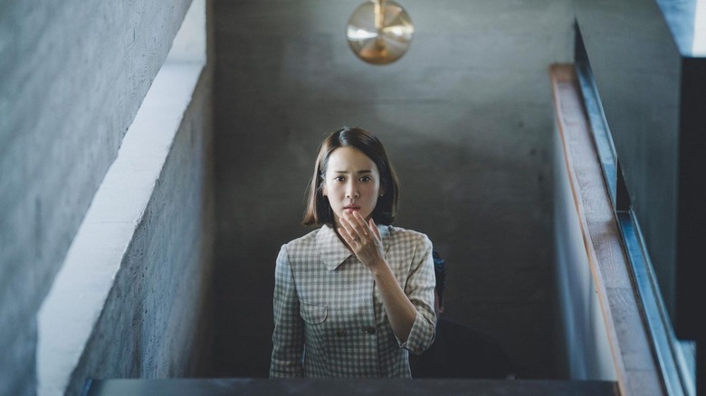 Mrs Park walking up the stairs frightened in Parasite