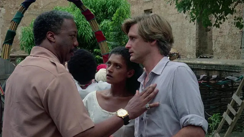 Lucien talking to Dennis and Marielle outside in The Serpent and the Rainbow