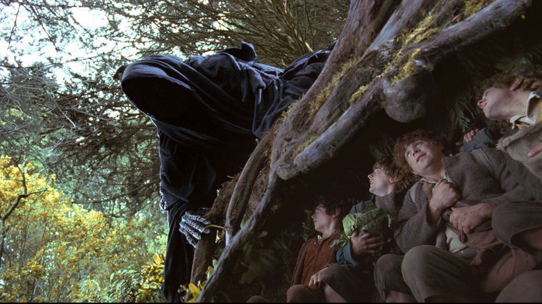 The hobbits hide from a dark rider in 'The Lord of the Rings: The Fellowship of the Ring' (2001)