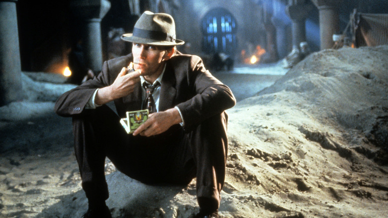 William Lee lights a cigarette in 'Naked Lunch' (1991)