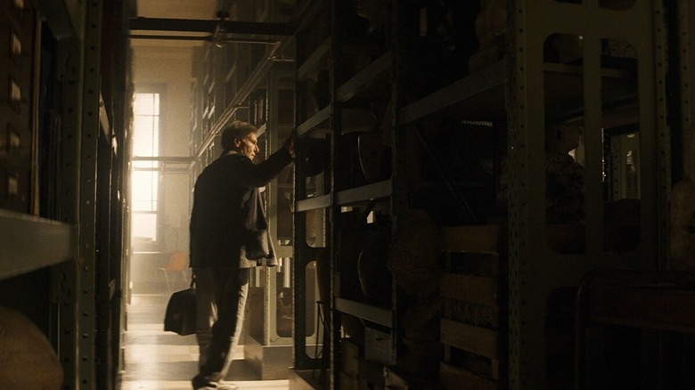 Indiana Jones entering dark room in Indiana Jones and the Dial of Destiny