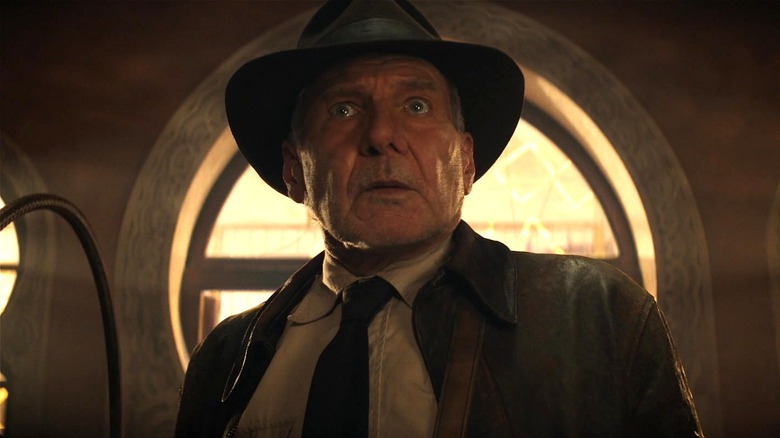 Indiana Jones looking nervous after snapping his whip in Indiana Jones and the Dial of Destiny
